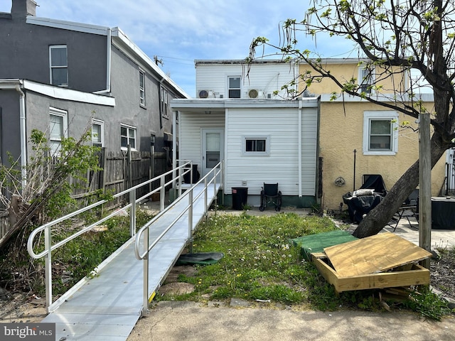 402 Market St, Marcus Hook, PA 19061 - rear view of house featuring fence and stucco siding