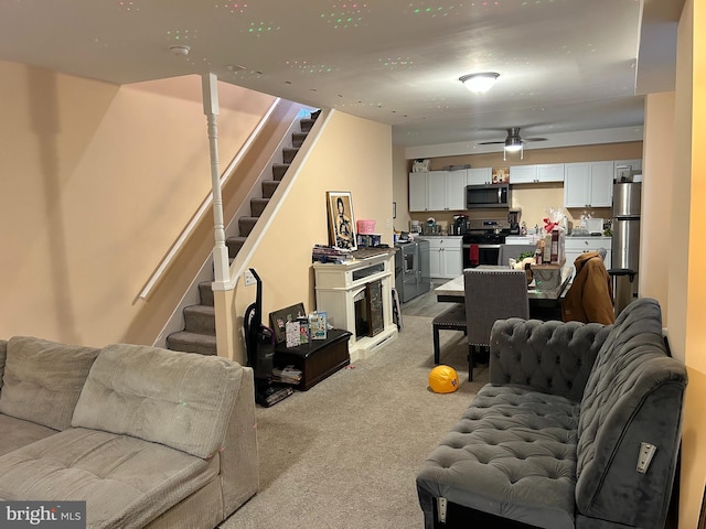 402 Market St, Marcus Hook, PA 19061 - living room featuring stairs, ceiling fan, and light colored carpet