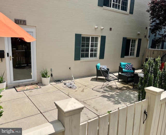view of patio / terrace with an outdoor hangout area and fence