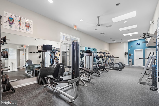 workout area with a skylight, recessed lighting, and baseboards