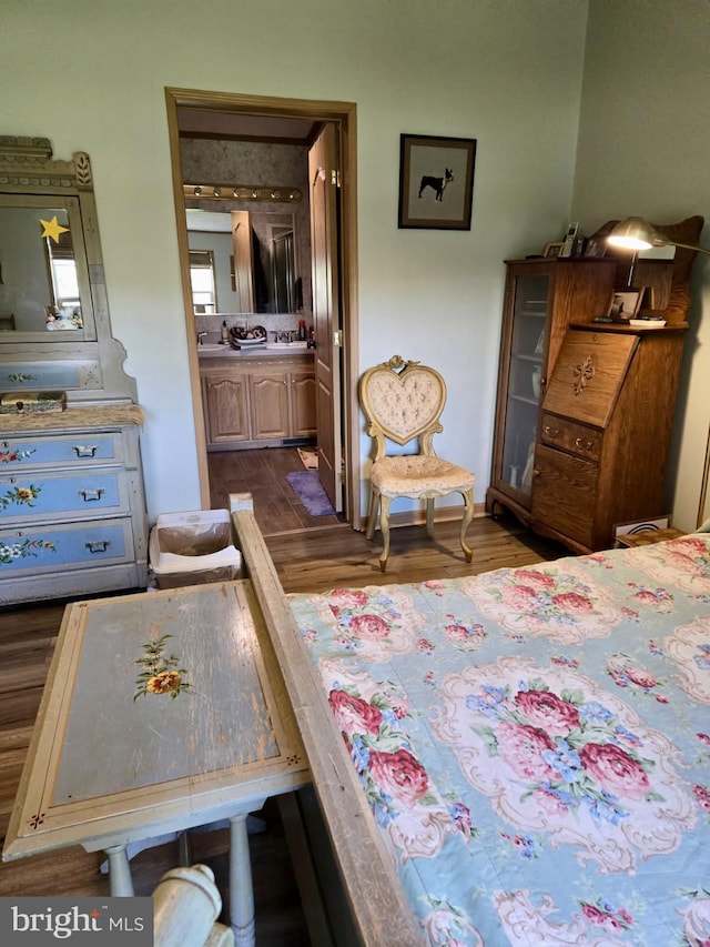 bedroom with dark wood-style flooring and ensuite bathroom
