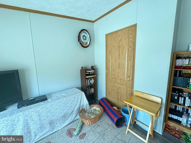 bedroom with crown molding and a textured ceiling