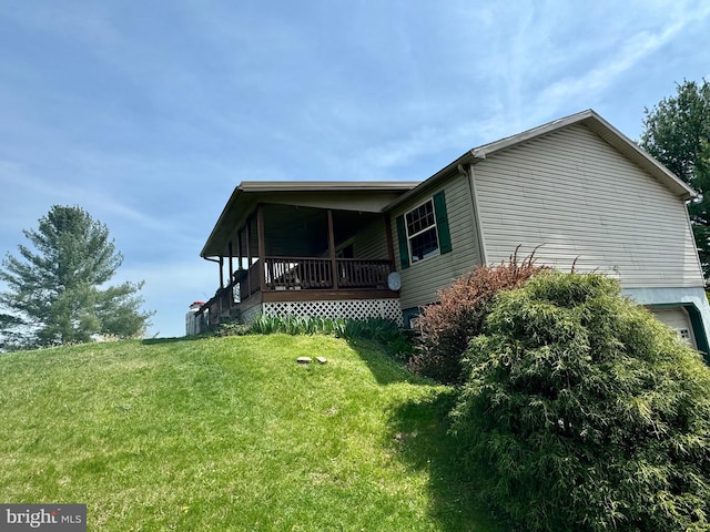 view of side of property with a yard and an attached garage