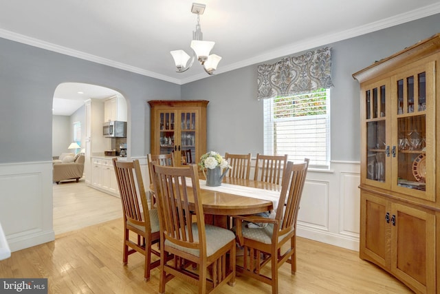 2914 6th St S, Arlington, VA 22204 - dining area with arched walkways, wainscoting, plenty of natural light, a chandelier, and light wood-type flooring
