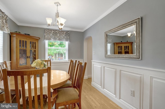 2914 6th St S, Arlington, VA 22204 - dining area with arched walkways, a chandelier, light wood finished floors, ornamental molding, and a wainscoted wall