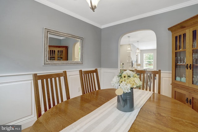 2914 6th St S, Arlington, VA 22204 - dining room featuring arched walkways, ornamental molding, a decorative wall, and a wainscoted wall