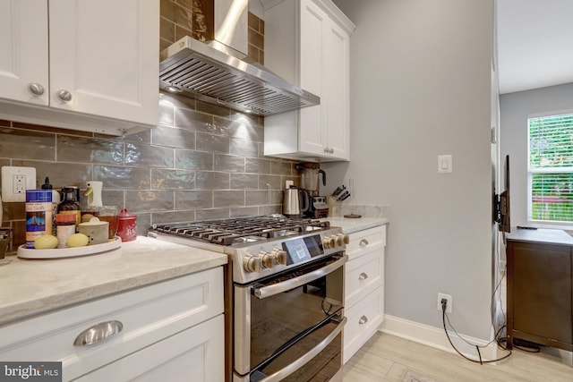2914 6th St S, Arlington, VA 22204 - kitchen with double oven range, wall chimney range hood, white cabinetry, backsplash, and light stone countertops