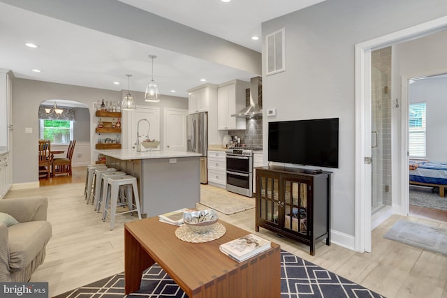 2914 6th St S, Arlington, VA 22204 - living area featuring light wood-type flooring, recessed lighting, arched walkways, and baseboards