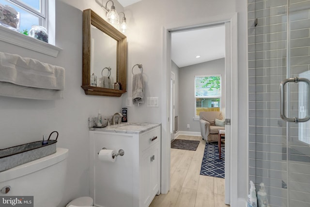 2914 6th St S, Arlington, VA 22204 - bathroom featuring wood finished floors, vanity, a shower with shower door, and toilet