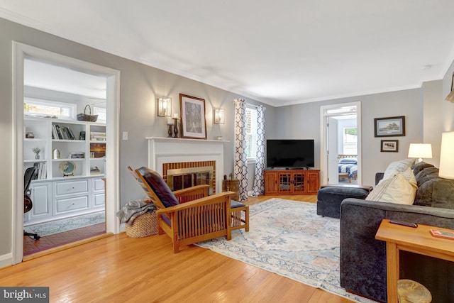 2914 6th St S, Arlington, VA 22204 - living room featuring wood finished floors, crown molding, and a brick fireplace