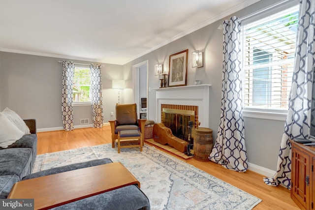 2914 6th St S, Arlington, VA 22204 - living area featuring wood finished floors, ornamental molding, a brick fireplace, and baseboards