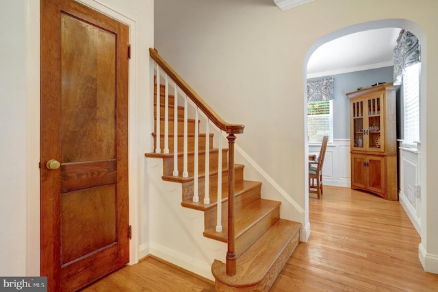 2914 6th St S, Arlington, VA 22204 - stairs featuring arched walkways, crown molding, wood finished floors, and wainscoting