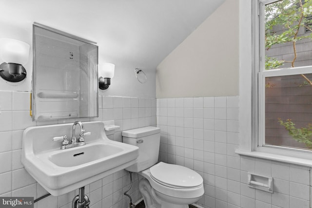 537 Baer Ave, Hanover, PA 17331 - half bath with tile walls, toilet, a sink, vaulted ceiling, and wainscoting