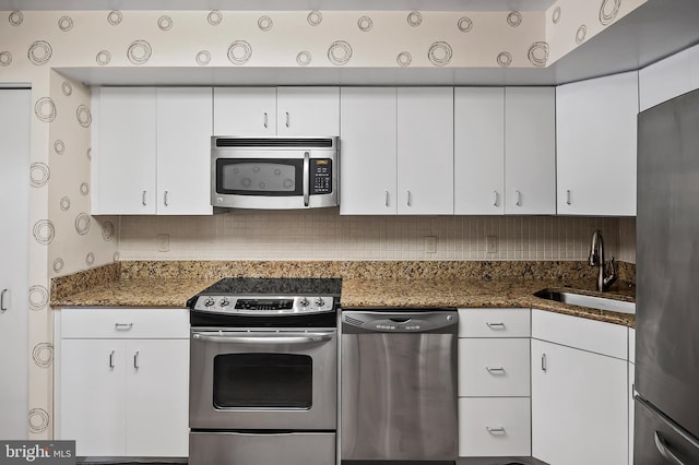 2 High Stepper Ct Unit 201, Baltimore, MD 21208 - kitchen featuring appliances with stainless steel finishes, a sink, white cabinetry, tasteful backsplash, and dark stone countertops