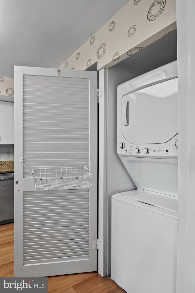2 High Stepper Ct Unit 201, Baltimore, MD 21208 - washroom with stacked washer / dryer and wood finished floors