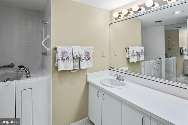 2 High Stepper Ct Unit 201, Baltimore, MD 21208 - bathroom featuring washer and clothes dryer, a bath, and vanity