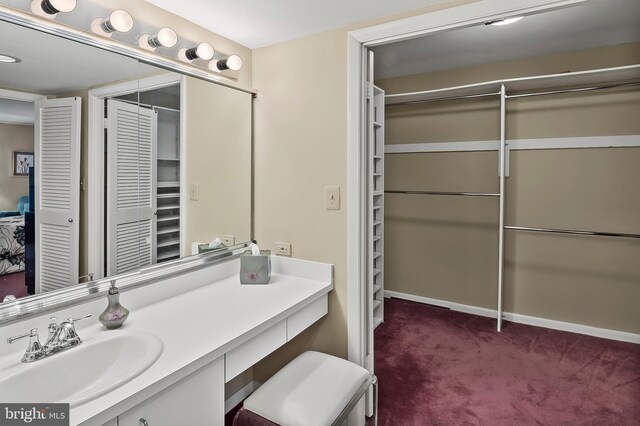 2 High Stepper Ct Unit 201, Baltimore, MD 21208 - bathroom featuring a closet, vanity, and baseboards
