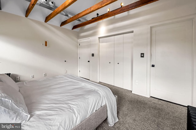carpeted bedroom featuring beamed ceiling