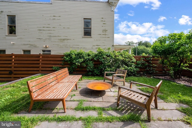 view of patio featuring fence and an outdoor fire pit
