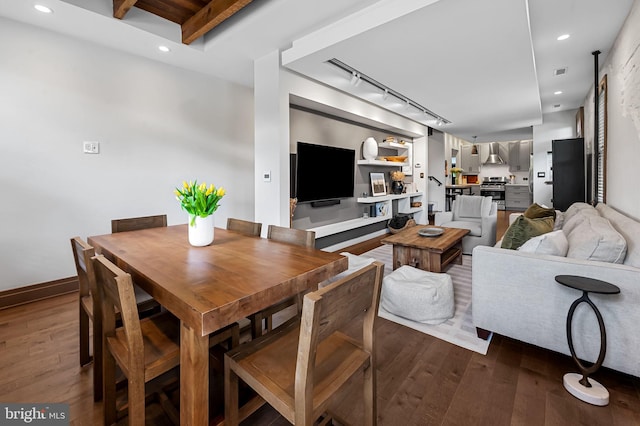 dining room with rail lighting, dark wood finished floors, and recessed lighting
