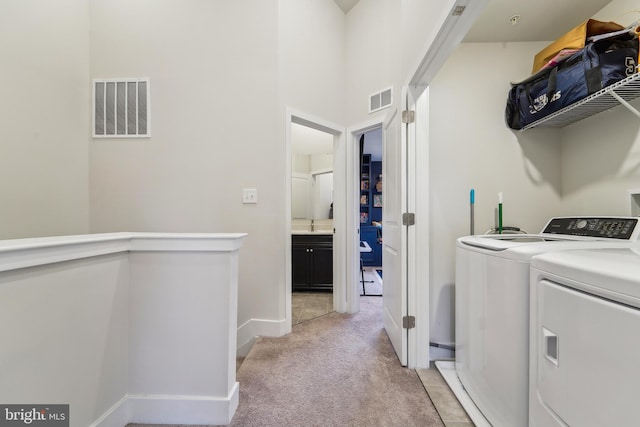 7853 Bluelick Run Rd, Baltimore, MD 21244 - laundry area with light carpet, washing machine and clothes dryer, and baseboards