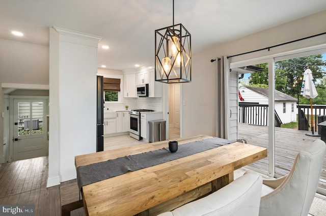 dining room featuring healthy amount of natural light, light wood-style flooring, and recessed lighting