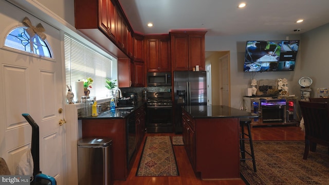 1834 Mower St, Philadelphia, PA 19152 - kitchen featuring appliances with stainless steel finishes, dark countertops, dark wood-style floors, dark brown cabinets, and recessed lighting