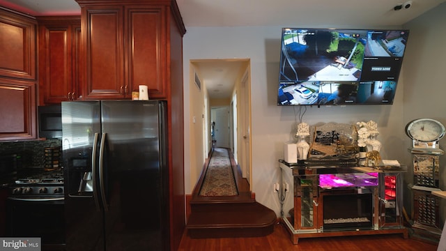 1834 Mower St, Philadelphia, PA 19152 - kitchen with stainless steel refrigerator with ice dispenser, black range with gas stovetop, wood finished floors, decorative backsplash, and dark brown cabinets