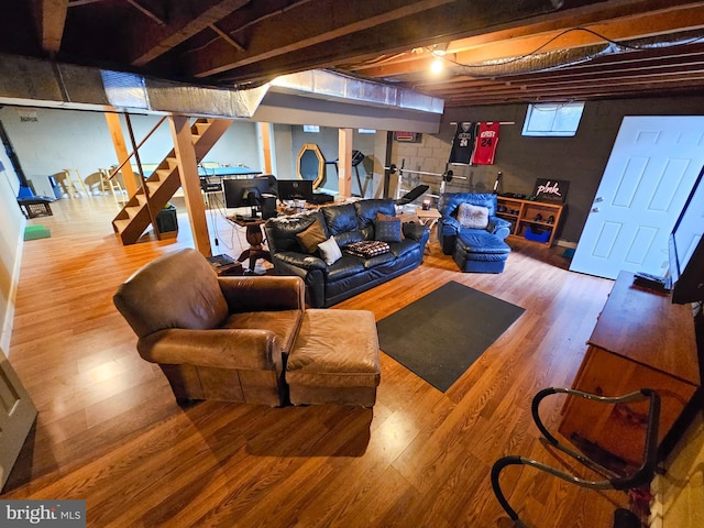 basement with wood finished floors and stairway