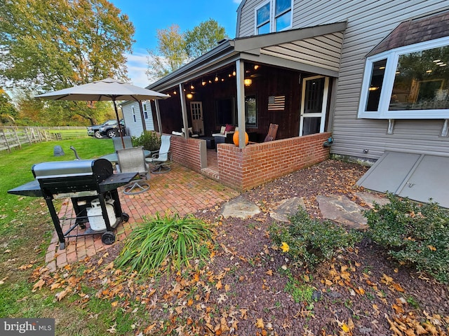view of patio / terrace with a sunroom and area for grilling