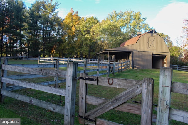gate featuring an outbuilding, a barn, and an exterior structure