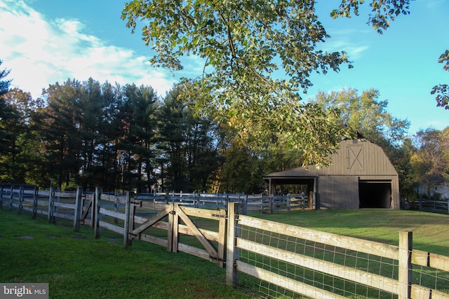 view of yard with a detached garage, an outbuilding, and a barn