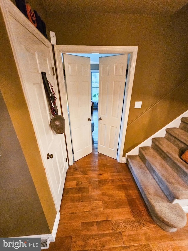entrance foyer with wood finished floors and stairs