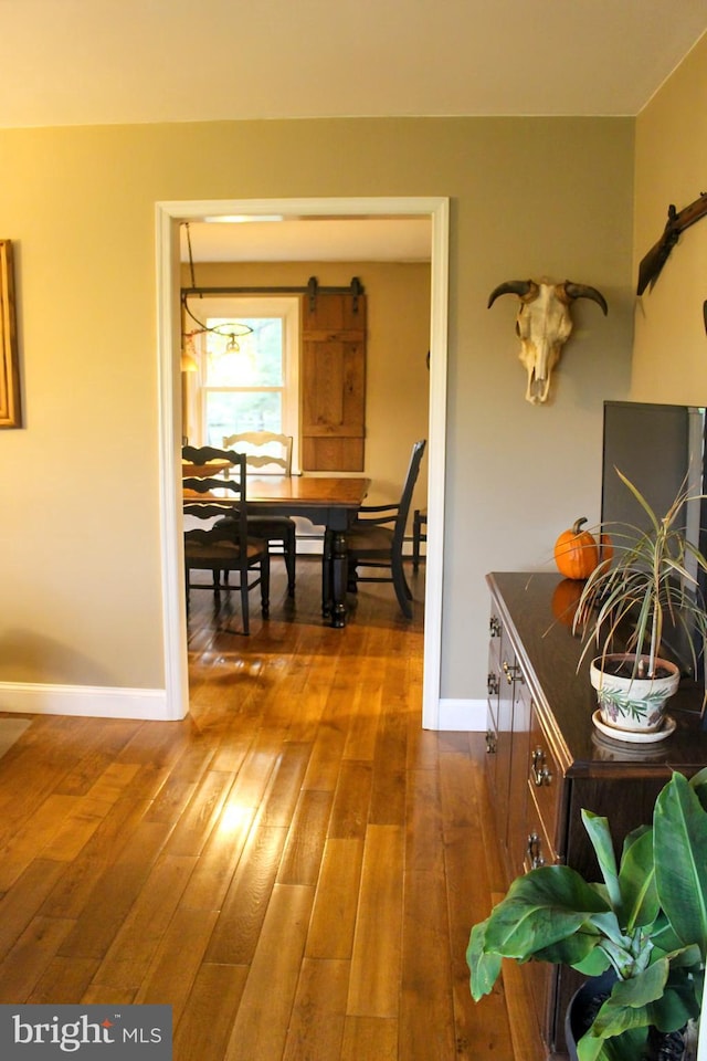 hallway with baseboards and dark wood-style floors