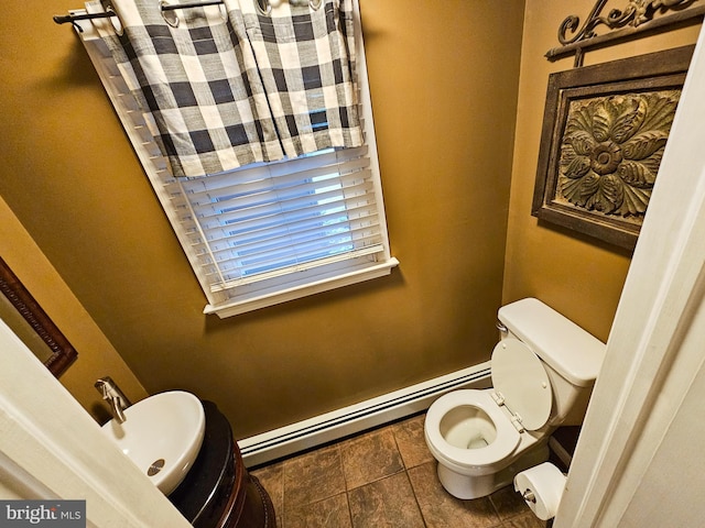 bathroom with toilet and baseboard heating