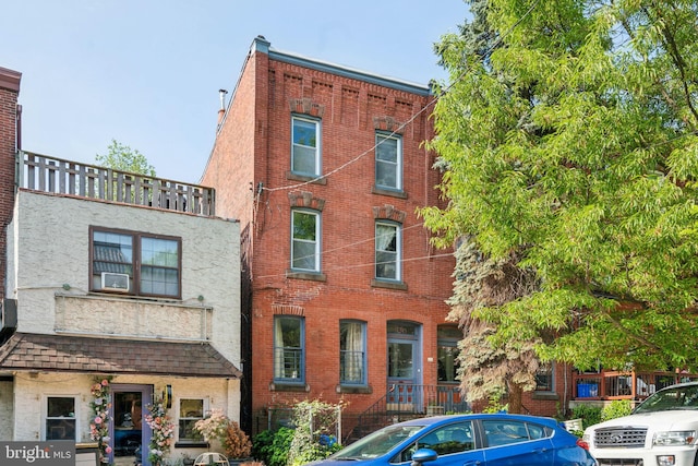 townhome / multi-family property featuring brick siding