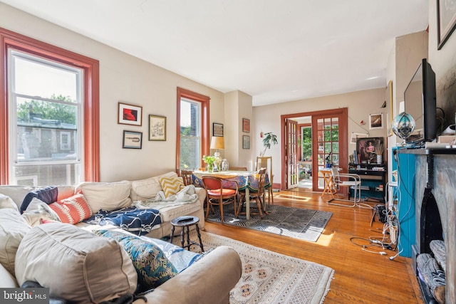 living area with wood finished floors and a fireplace with flush hearth