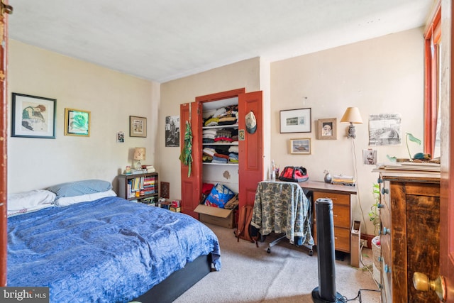 bedroom featuring light carpet