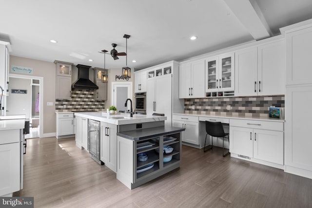 36 Boone Trl, Severna Park, MD 21146 - kitchen with premium range hood, oven, wine cooler, a ceiling fan, and decorative backsplash