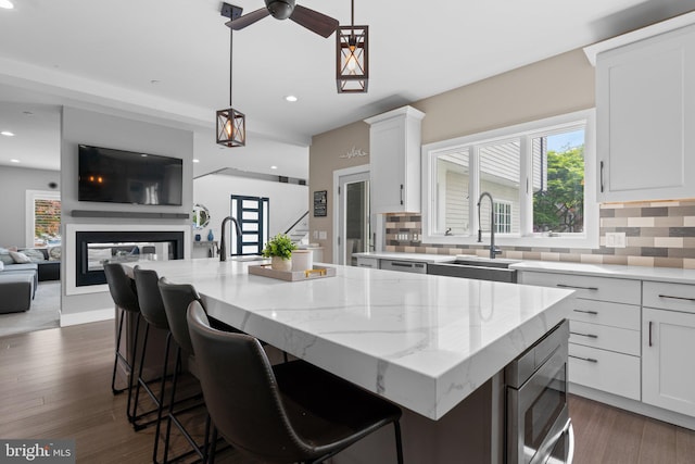 36 Boone Trl, Severna Park, MD 21146 - kitchen featuring a sink, decorative backsplash, light stone counters, and recessed lighting