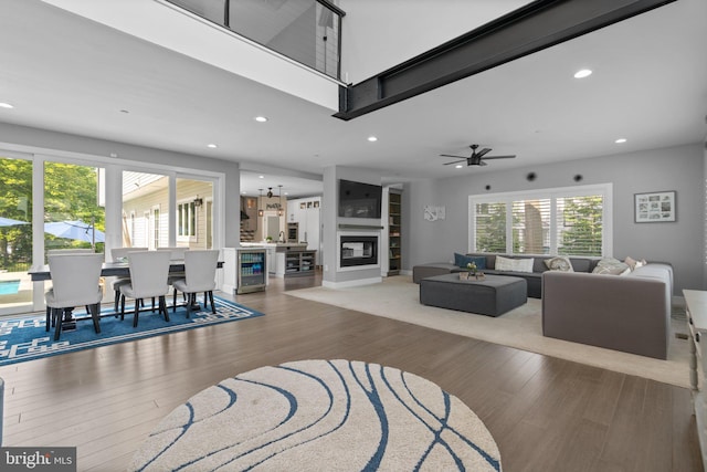 36 Boone Trl, Severna Park, MD 21146 - living room with recessed lighting, wood finished floors, wine cooler, a ceiling fan, and a glass covered fireplace