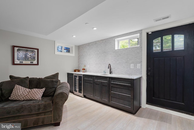 36 Boone Trl, Severna Park, MD 21146 - bar area featuring wine cooler, a sink, decorative backsplash, recessed lighting, and light wood-style flooring