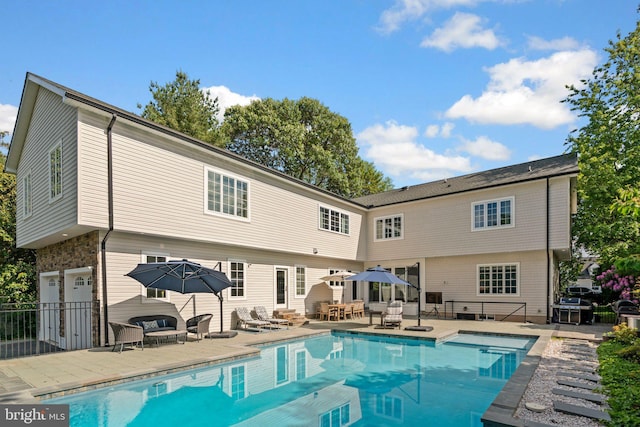 36 Boone Trl, Severna Park, MD 21146 - rear view of house with an outdoor hangout area, an outdoor pool, a patio area, and an attached garage