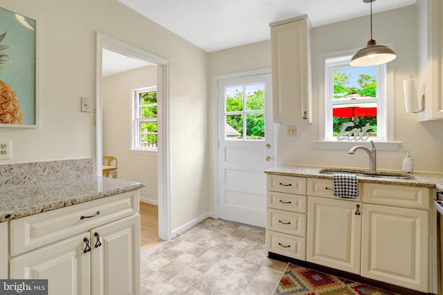 1807 N Barton St, Arlington, VA 22201 - kitchen with a sink, light stone countertops, baseboards, and decorative light fixtures