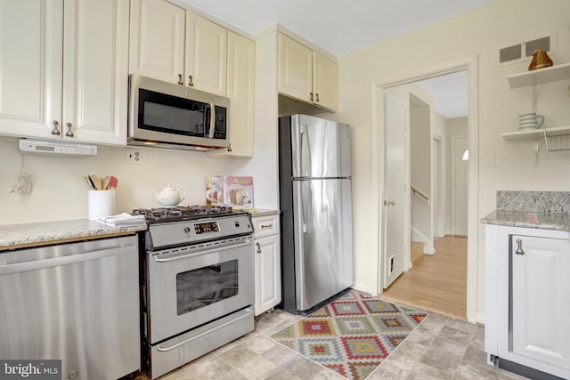1807 N Barton St, Arlington, VA 22201 - kitchen with stainless steel appliances, open shelves, light stone countertops, and cream cabinets