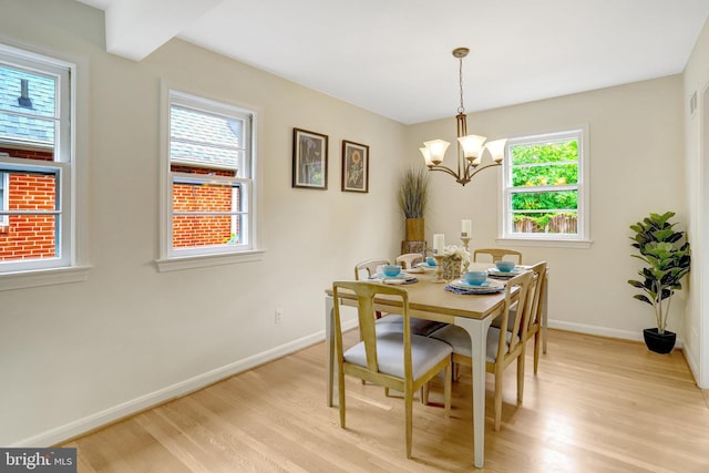 1807 N Barton St, Arlington, VA 22201 - dining area with light wood-type flooring, baseboards, and a chandelier