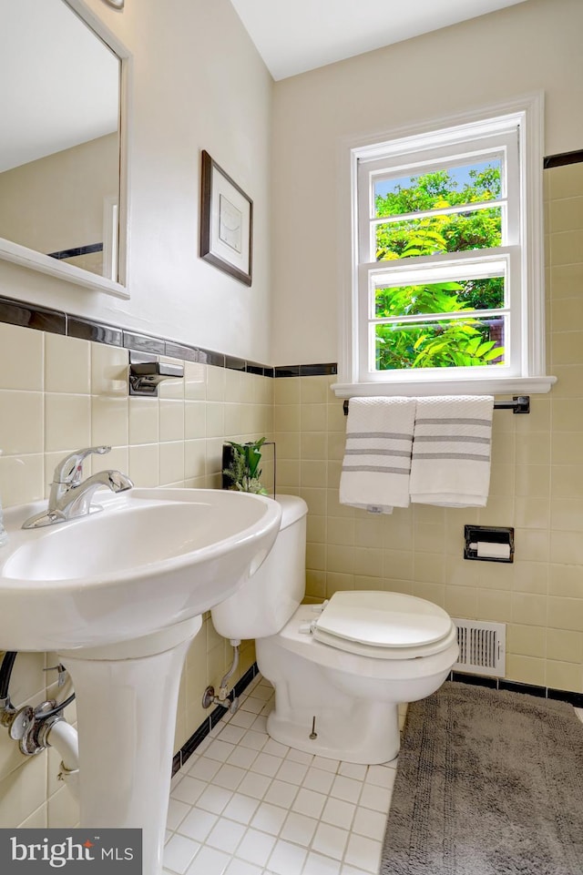 1807 N Barton St, Arlington, VA 22201 - half bathroom featuring tile patterned flooring, tile walls, toilet, and wainscoting