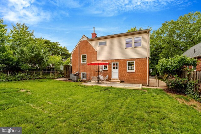 1807 N Barton St, Arlington, VA 22201 - rear view of house with entry steps, brick siding, a chimney, a patio, and cooling unit