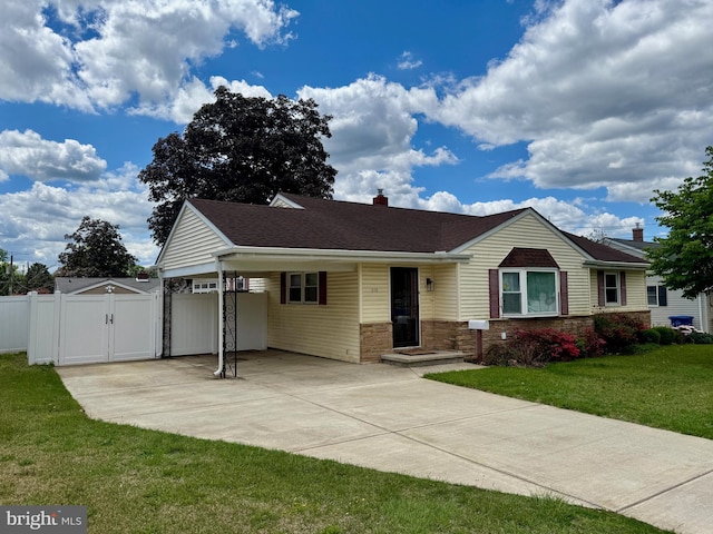 ranch-style house with a gate, a carport, concrete driveway, and a chimney