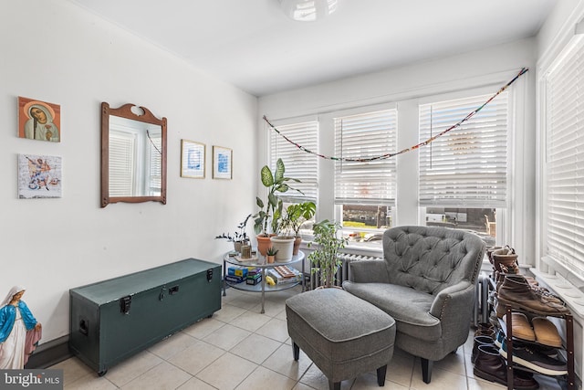 living area with healthy amount of natural light and light tile patterned floors